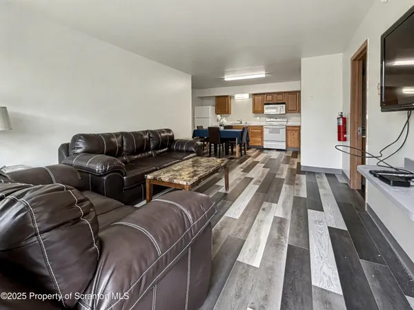 a living room with furniture fireplace and flat screen tv
