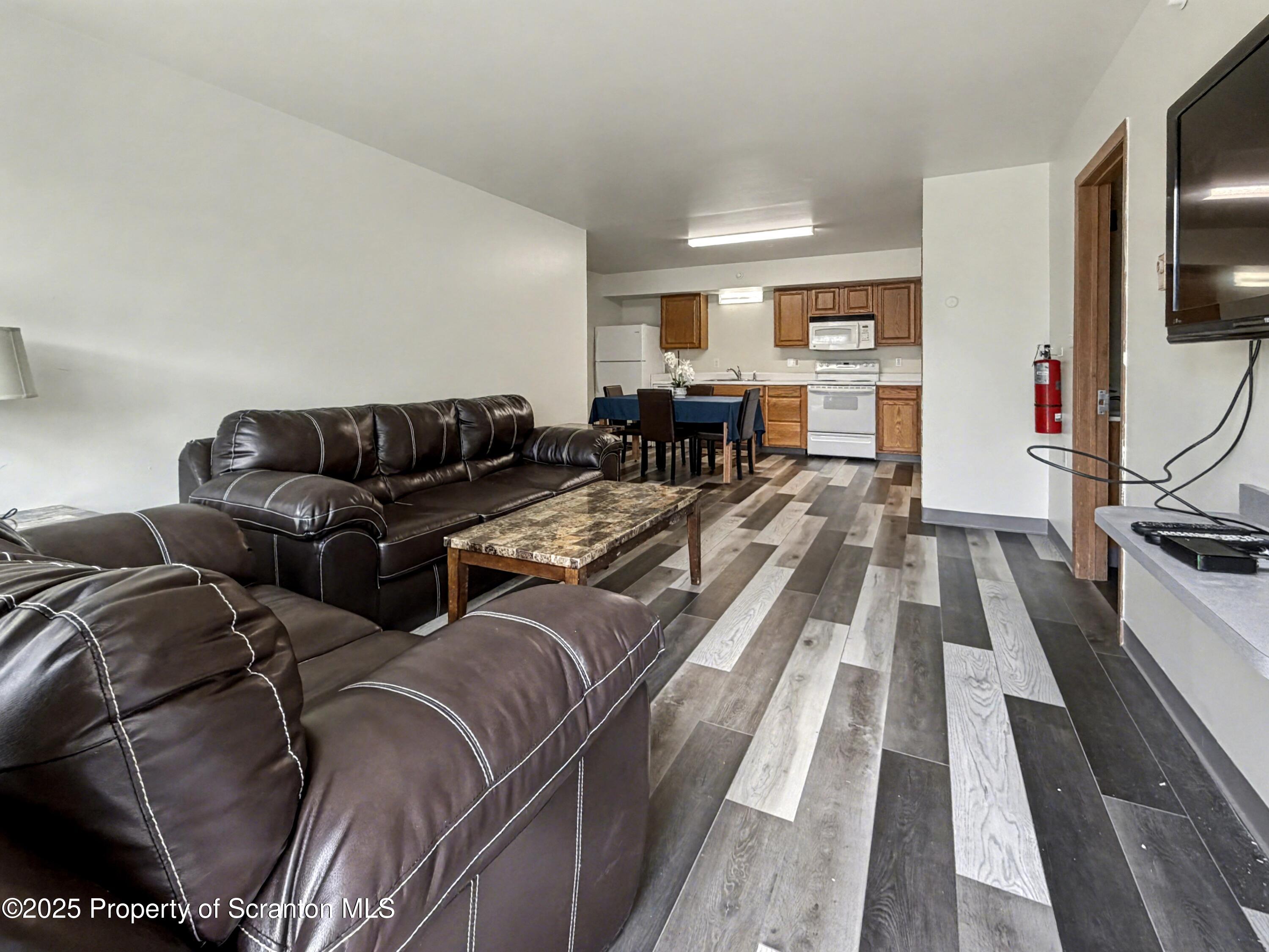 42 Nittany Drive, Unit HEMLOCK 4 Dallas, PA 18612 - Photo 2 of 13 a living room with furniture fireplace and flat screen tv