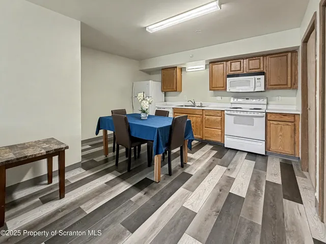 a kitchen with stainless steel appliances granite countertop a stove a sink dishwasher and a refrigerator