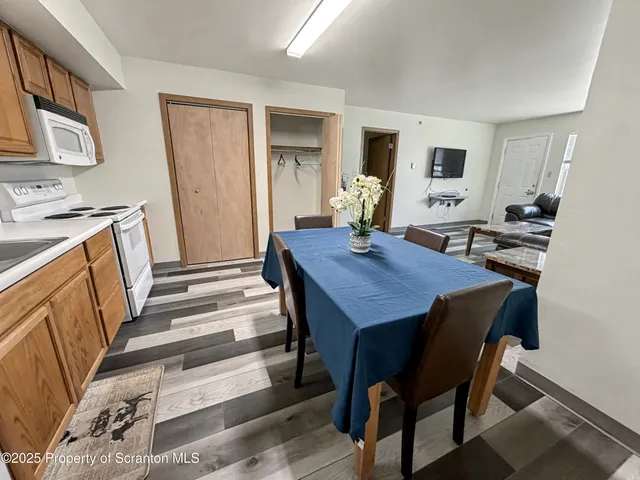 a view of a dining room with furniture and wooden floor
