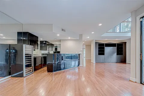 a bathroom with a granite countertop toilet and a sink