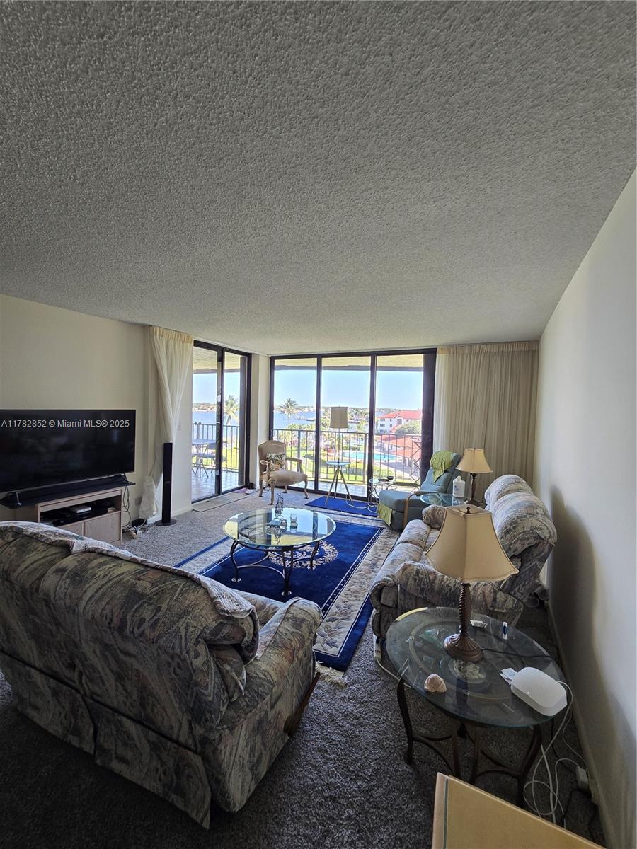 7020 Half Moon Circle, Unit 511 Hypoluxo, FL 33462 - Photo 14 of 28 a living room with furniture and a fireplace