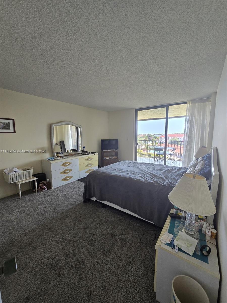 7020 Half Moon Circle, Unit 511 Hypoluxo, FL 33462 - Photo 9 of 28 a bedroom with a bed and a window