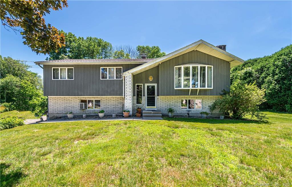 7 Caulkins Road Norwich, CT 06360 - Photo 1 of 1 a front view of a house with a yard