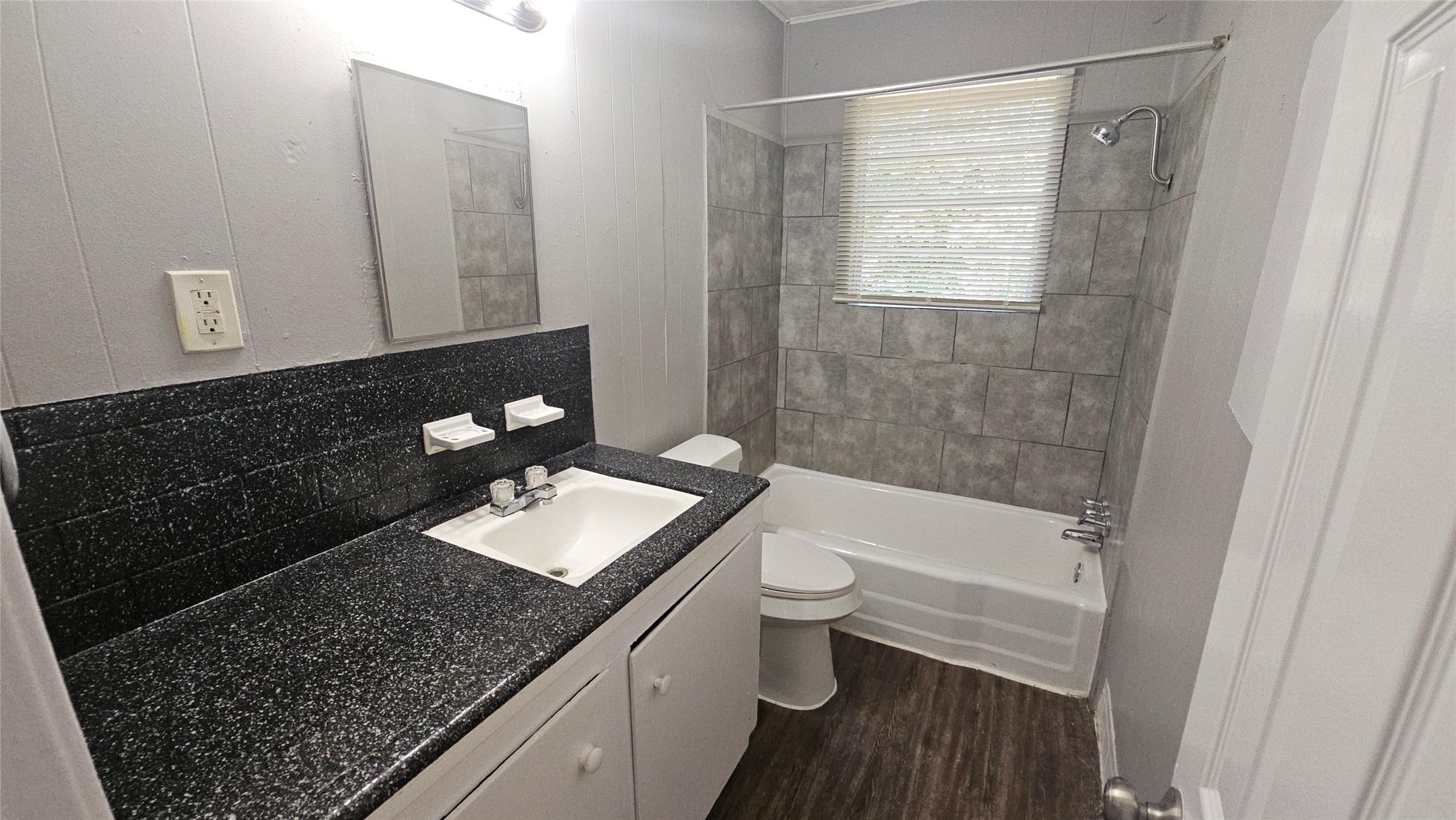 10806 Safeguard Street Houston, TX 77047 - Photo 7 of 10 a bathroom with a granite countertop sink toilet and shower