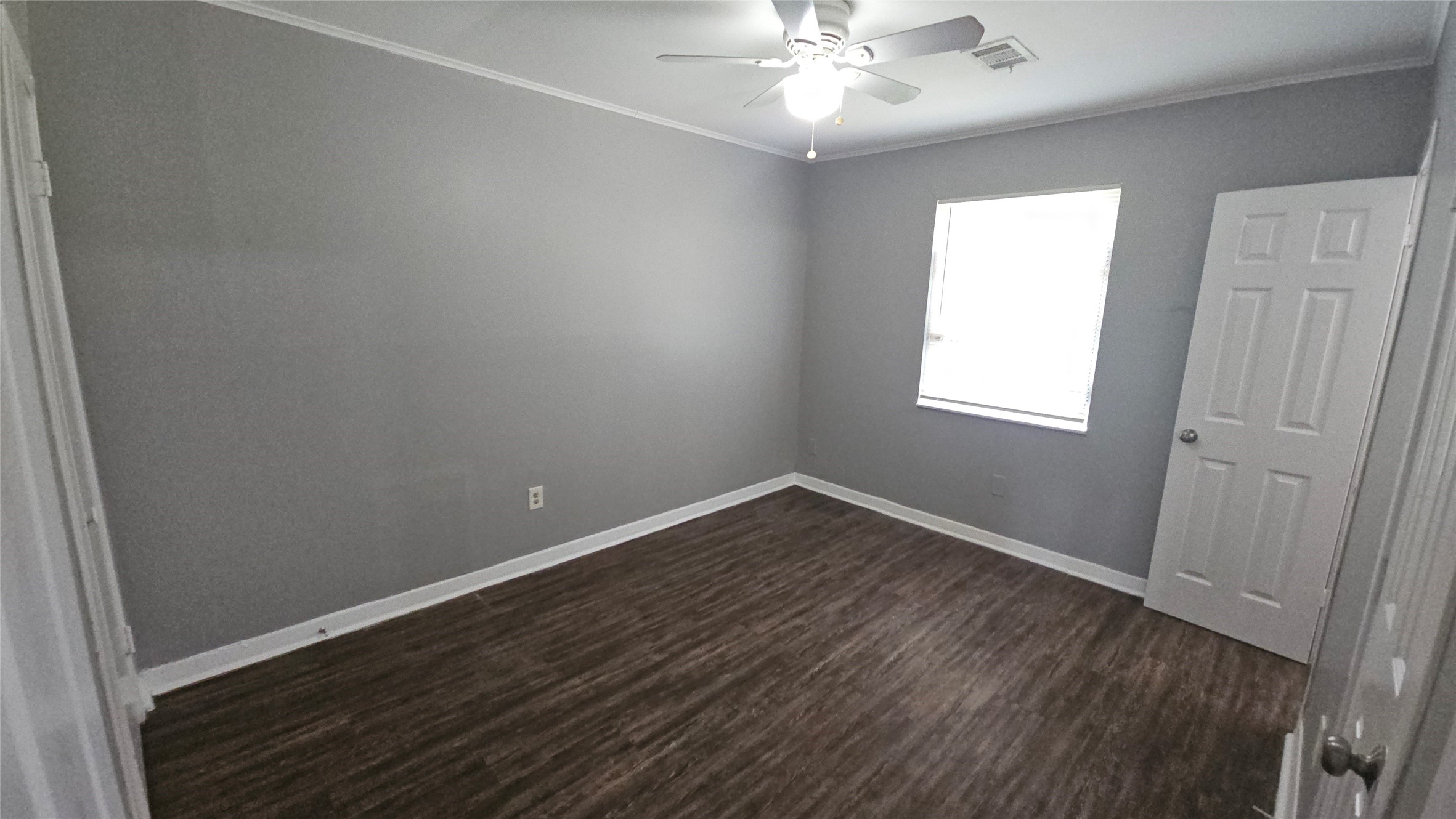 10806 Safeguard Street Houston, TX 77047 - Photo 8 of 10 an empty room with wooden floor and windows