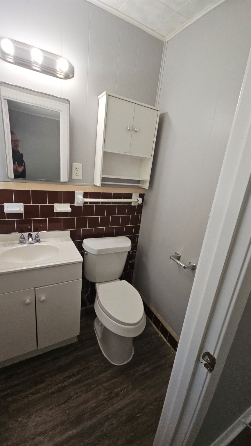 10806 Safeguard Street Houston, TX 77047 - Photo 9 of 10 a bathroom with a toilet sink and mirror