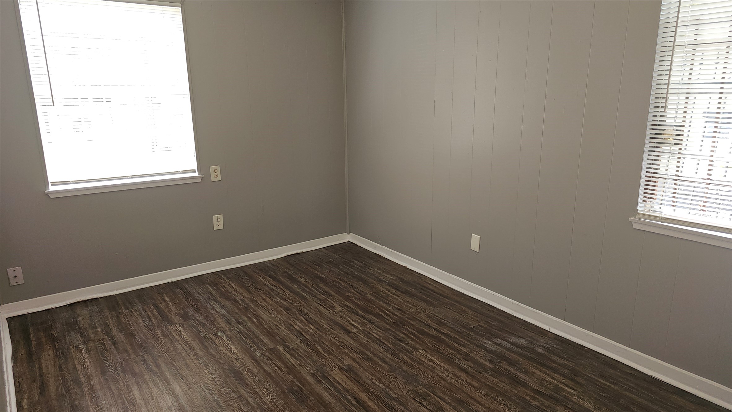 10806 Safeguard Street Houston, TX 77047 - Photo 10 of 10 an empty room with wooden floor and windows