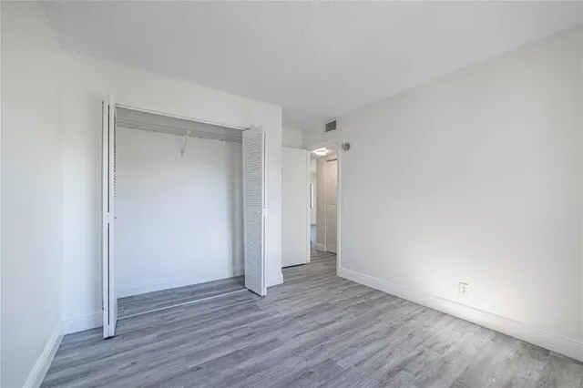 a view of an empty room and wooden floor