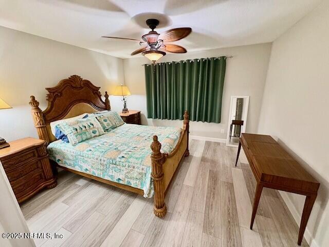 17 Arbor Club Drive, Unit 212 Ponte Vedra Beach, FL 32082 - Photo 19 of 29 a bedroom with a bed and a chandelier