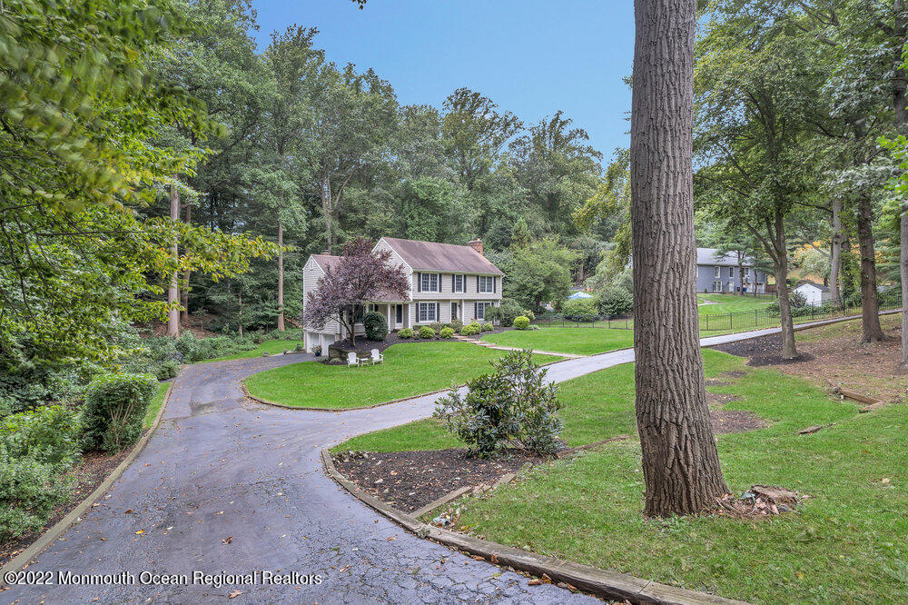 409 Dwight Road Middletown, NJ 07748 - Photo 3 of 53 a view of a garden with a fountain