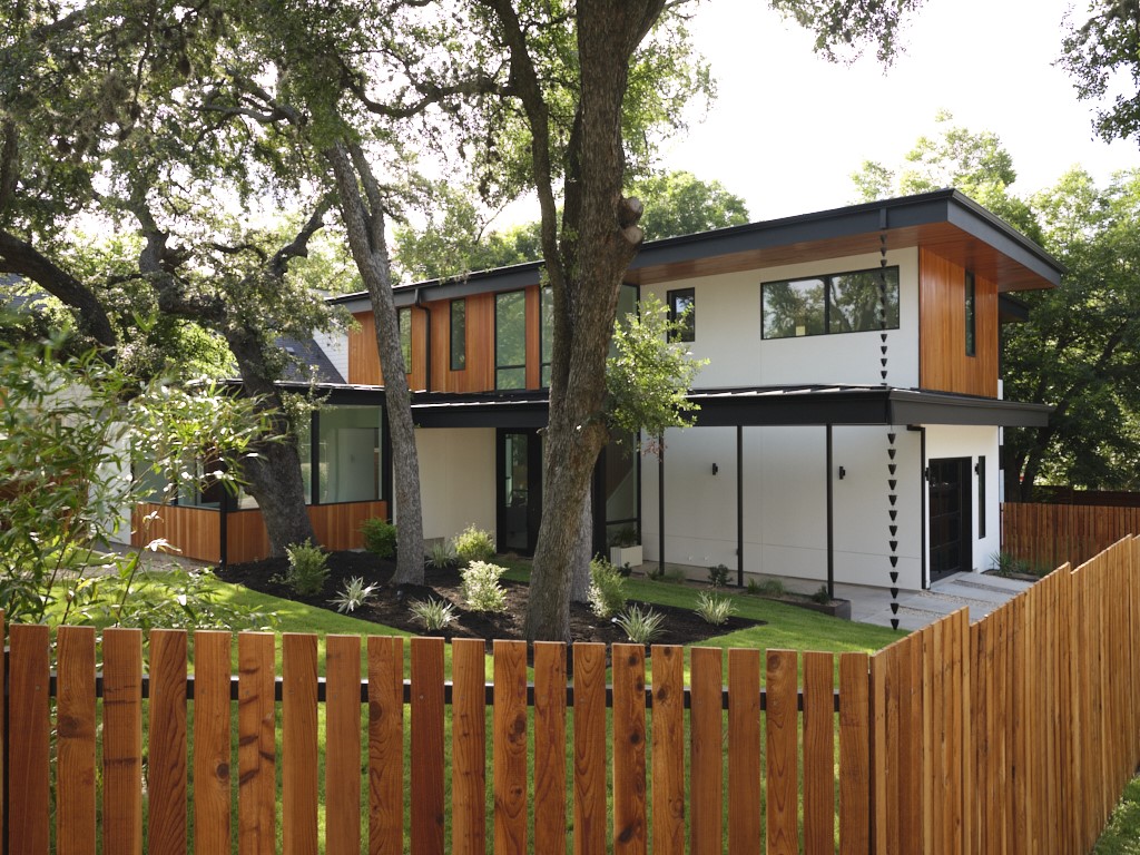 a front view of house with wooden fence