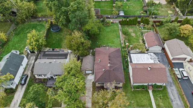 an aerial view of multiple houses with yard