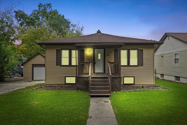 a front view of a house with a garden