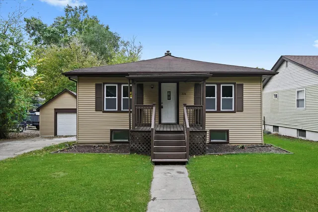 a front view of a house with a garden