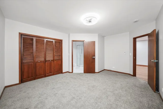 a view of an empty room with closet area
