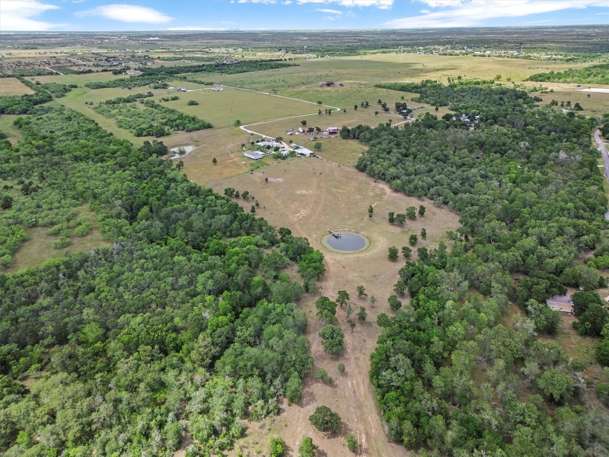 480 Grandpa Road Lockhart, TX 78644 - Photo 4 of 35 Tucked away on nearly 37 acres of peaceful Texas countryside, this one-of-a-kind property offers incredible versatility
with over $250,000 in improvements and four unique structures—making it the perfect canvas for a family compound,
creative retreat, or income-producing estate.