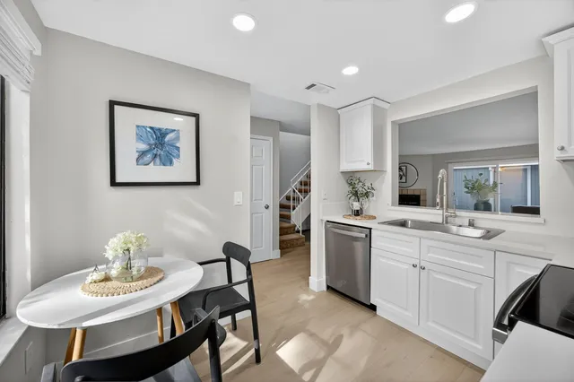a kitchen with a table and chairs in it
