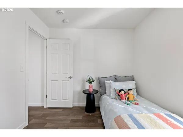 a view of a hallway with closet and toys