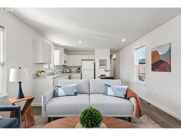 a living room with furniture and kitchen view