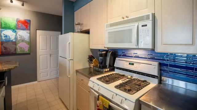 a kitchen with a stove and a refrigerator