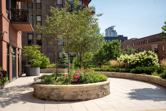 a view of a flower garden in front of a house