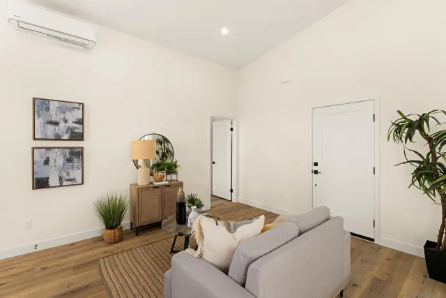 a living room with furniture and wooden floor