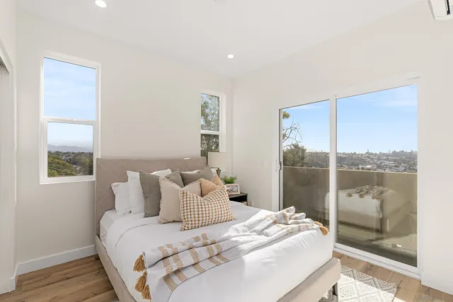 a bedroom with a large bed and a large window