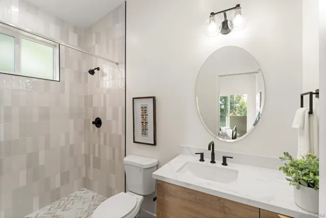 a bathroom with a sink toilet and shower