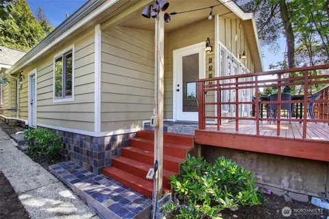 a view of a house with a window and wooden fence