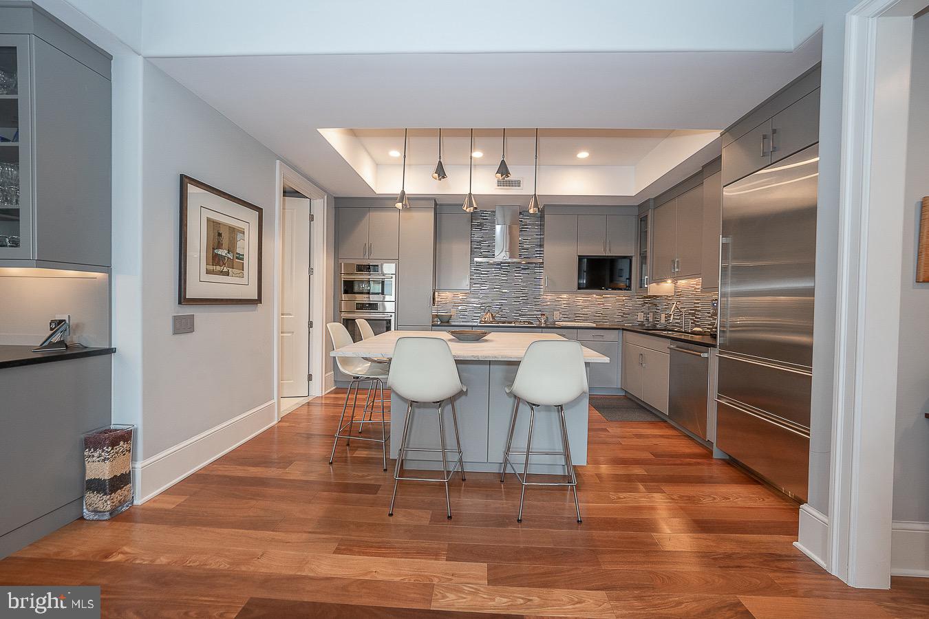 100 St Georges Road, Unit A3 Ardmore, PA 19003 - Photo 13 of 43 a kitchen with a dining table chairs and stainless steel appliances