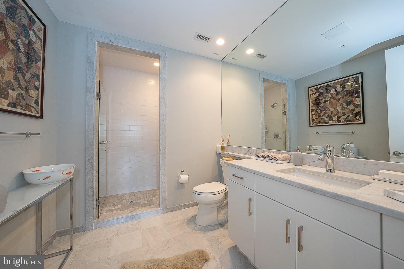 100 St Georges Road, Unit A3 Ardmore, PA 19003 - Photo 31 of 43 a bathroom with a toilet sink and mirror