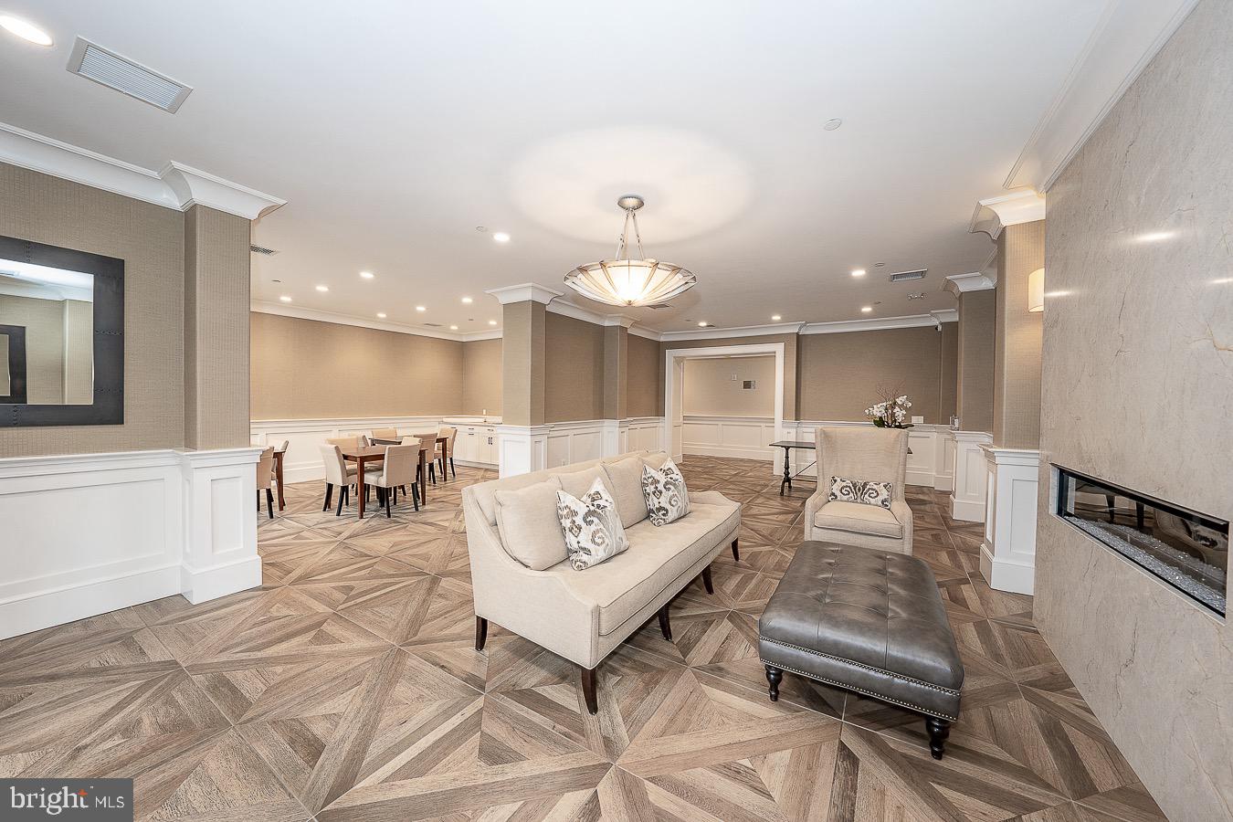 100 St Georges Road, Unit A3 Ardmore, PA 19003 - Photo 42 of 43 a living room with furniture a table and kitchen view
