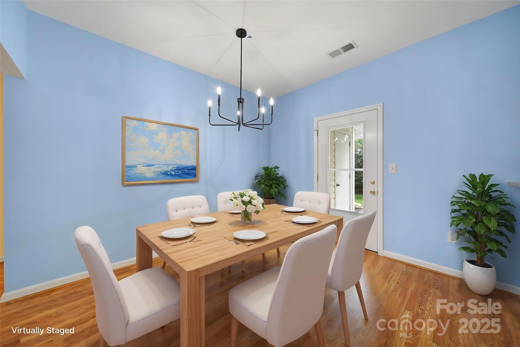 614 Stone Village Drive Fort Mill, SC 29708 - Photo 11 of 42 a view of a dining room with furniture wooden floor and a chandelier