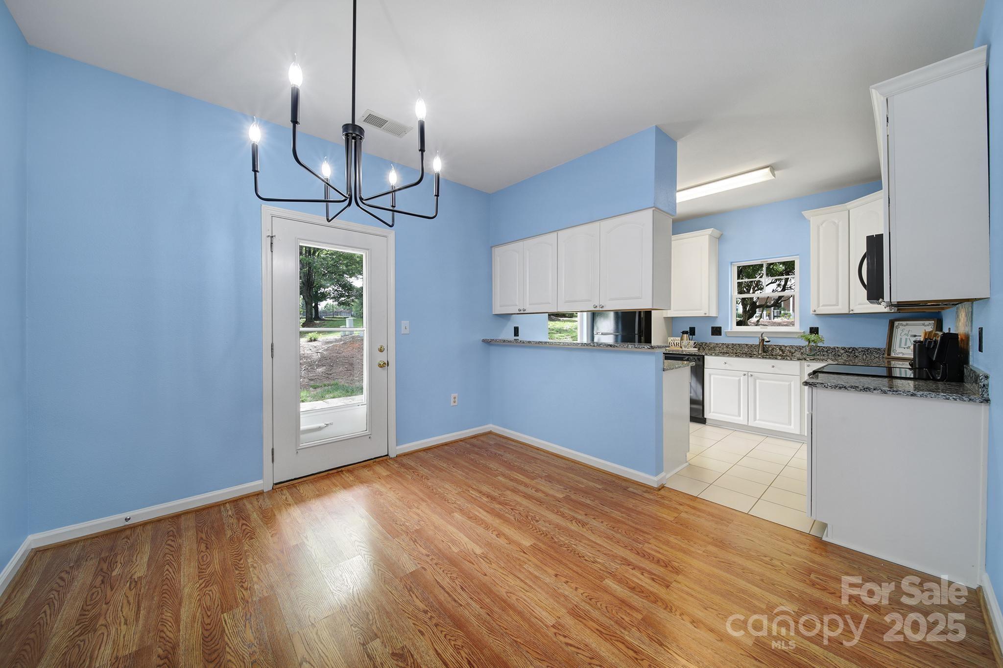 614 Stone Village Drive Fort Mill, SC 29708 - Photo 14 of 42 a open kitchen with wooden floor and stainless steel appliances