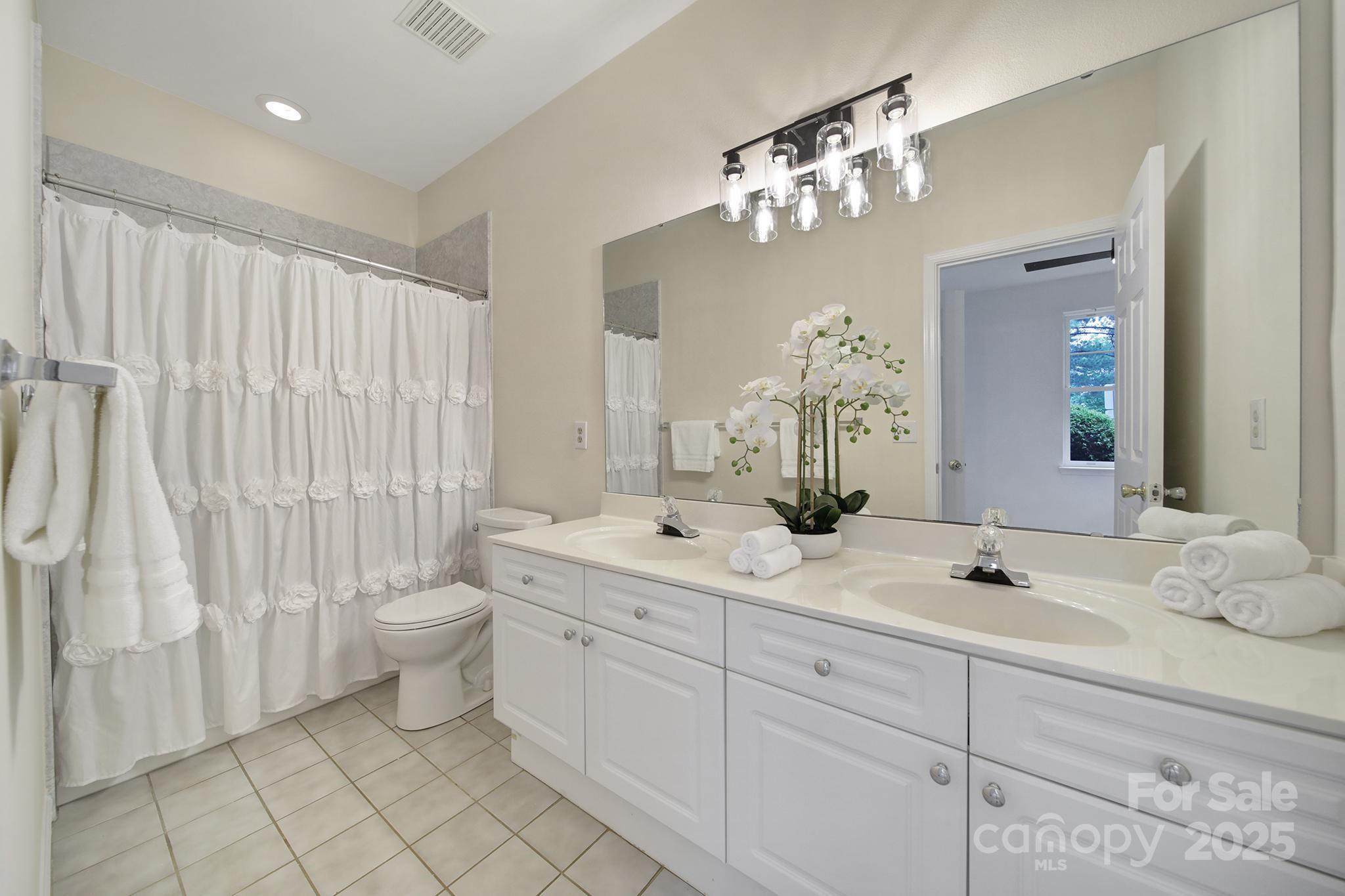 614 Stone Village Drive Fort Mill, SC 29708 - Photo 19 of 42 a bathroom with a double vanity sink mirror and toilet