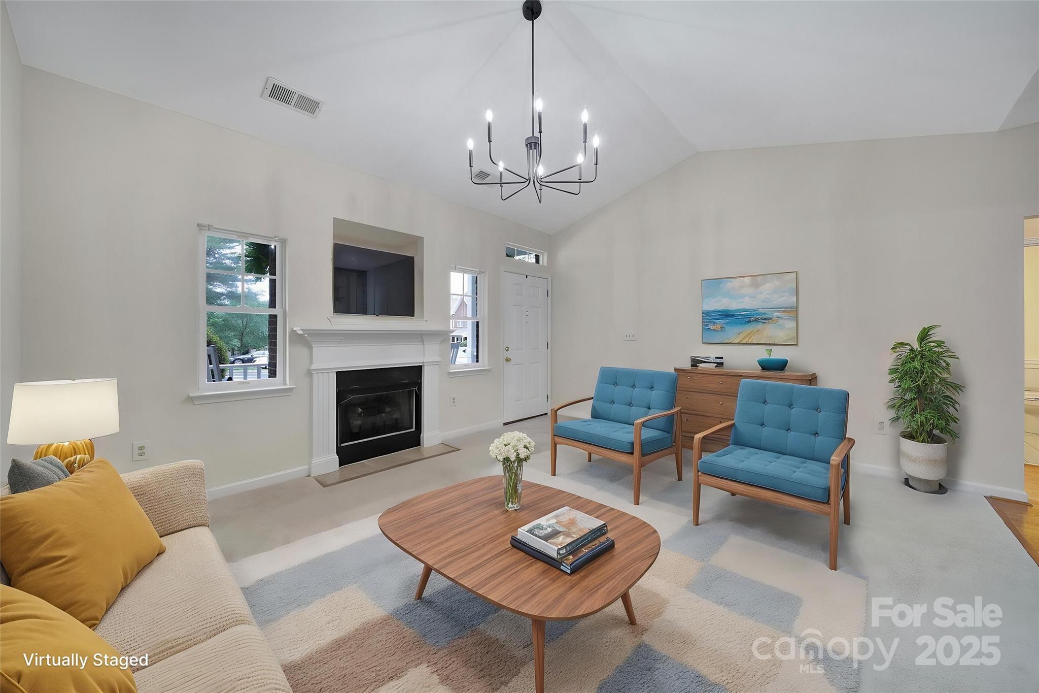 614 Stone Village Drive Fort Mill, SC 29708 - Photo 3 of 42 a living room with furniture a fireplace and a flat screen tv