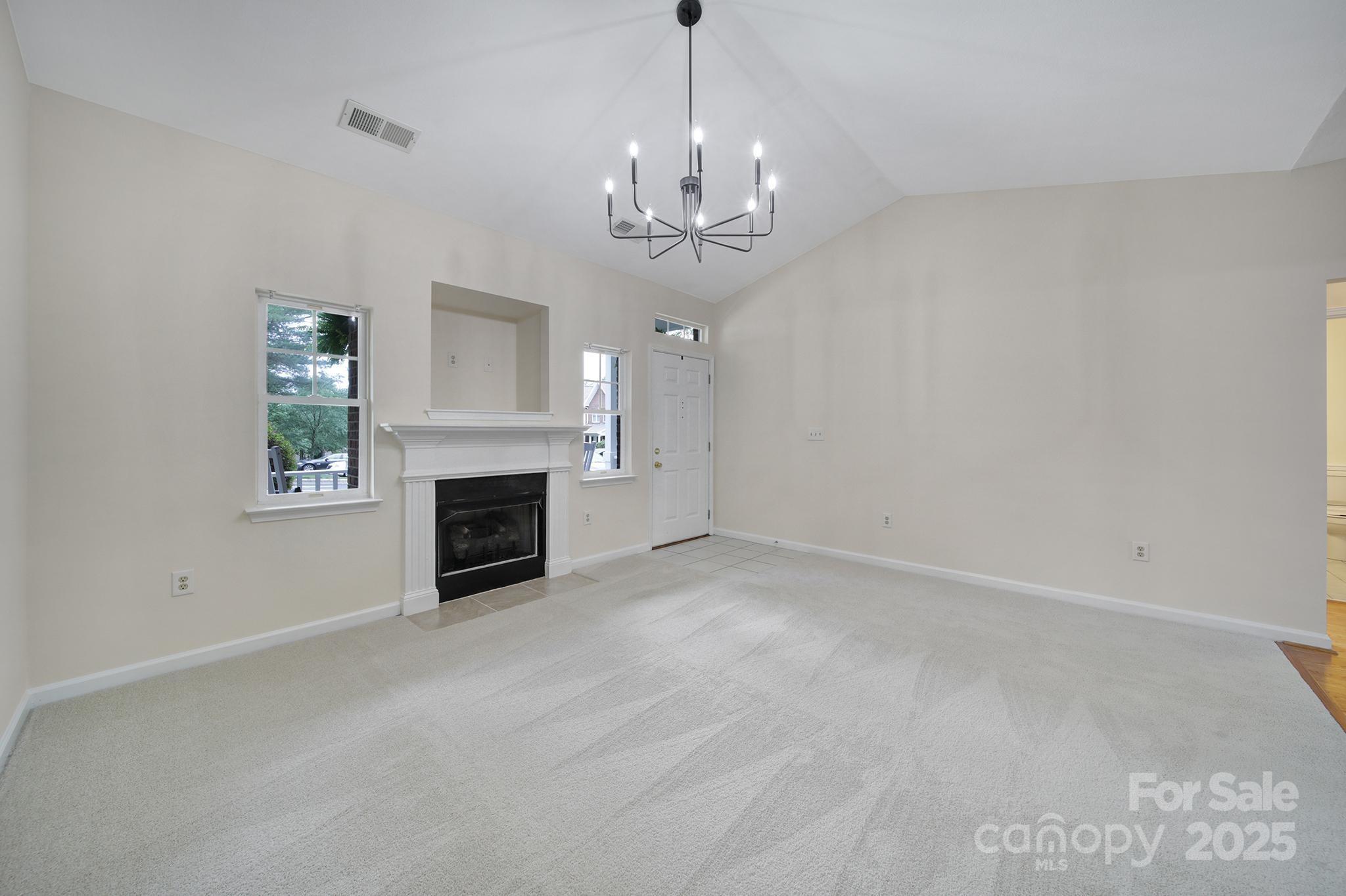 614 Stone Village Drive Fort Mill, SC 29708 - Photo 4 of 42 wooden floor and chandelier in fireplace