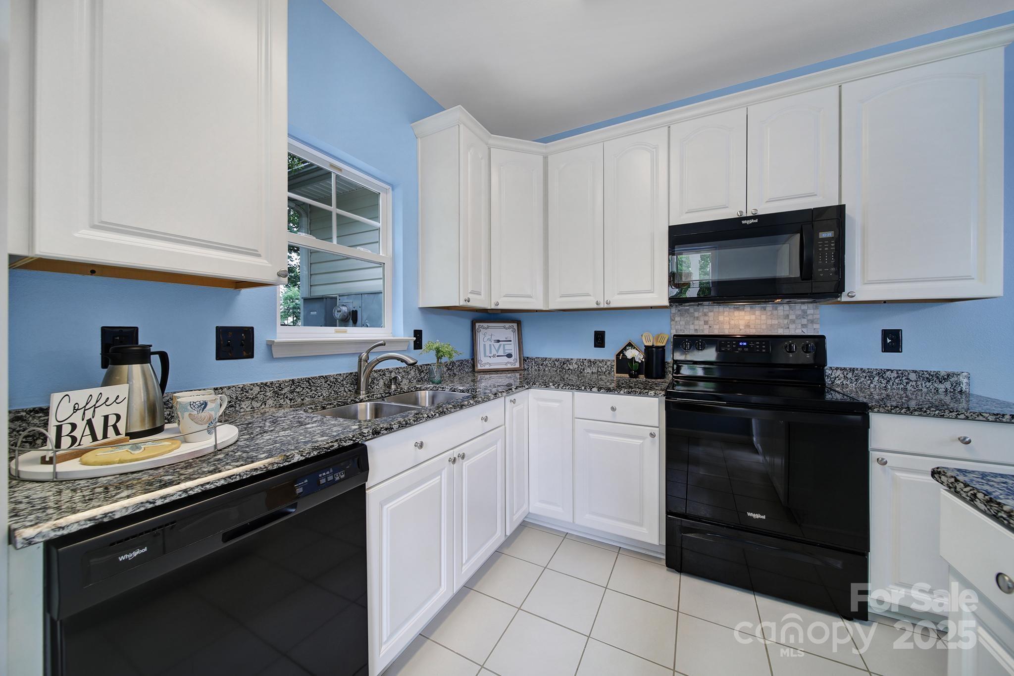 614 Stone Village Drive Fort Mill, SC 29708 - Photo 7 of 42 a kitchen with granite countertop a sink dishwasher stove and cabinets