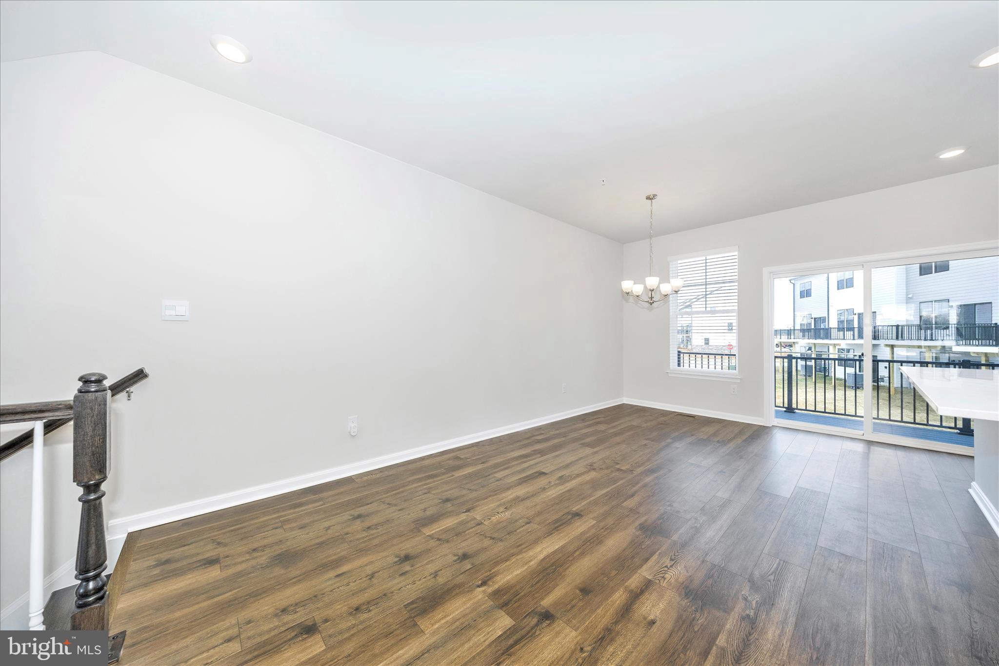 726 Compass Way Frederick, MD 21701 - Photo 14 of 55 a view of empty room with wooden floor