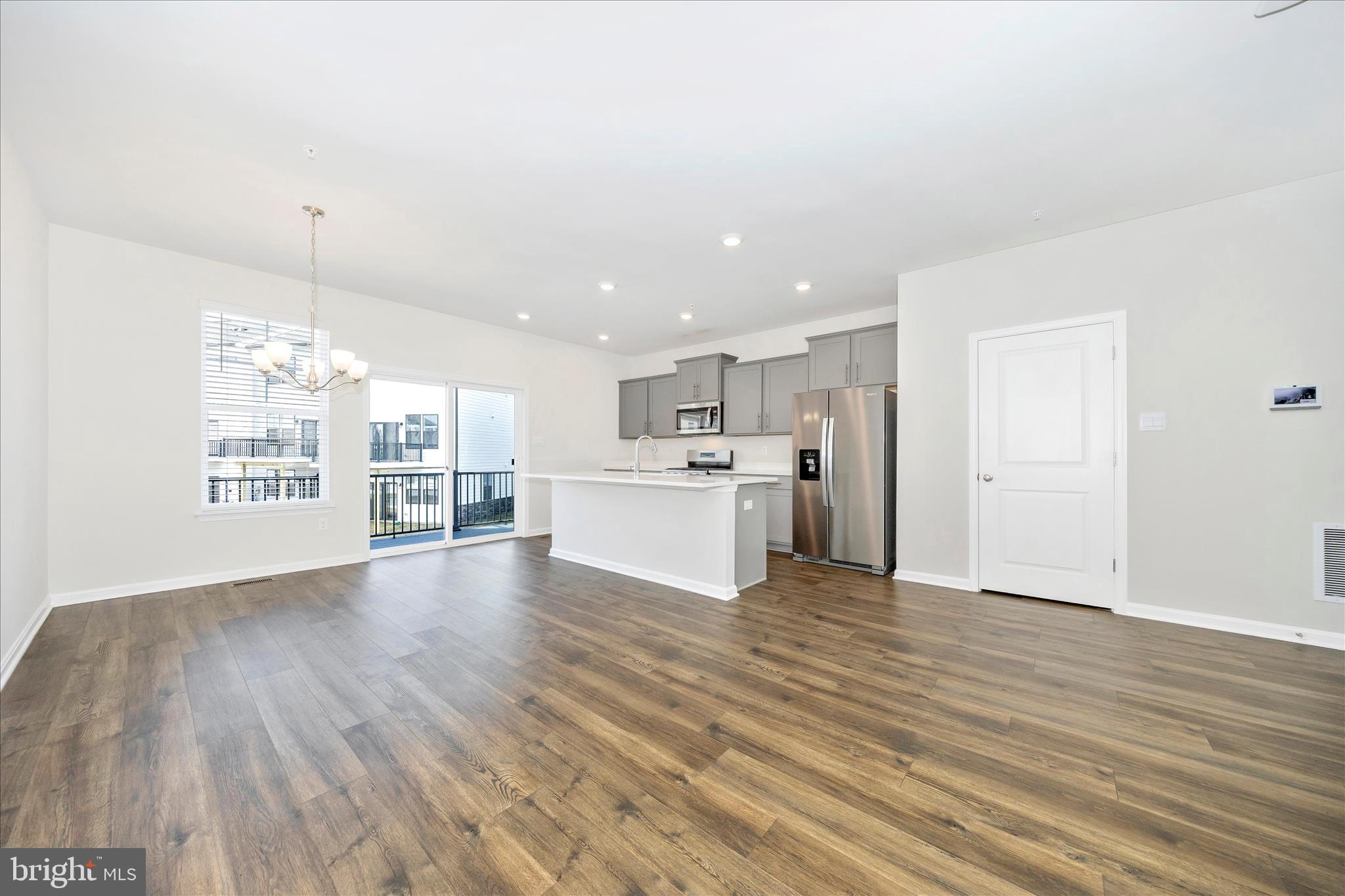 726 Compass Way Frederick, MD 21701 - Photo 15 of 55 a view of a kitchen with wooden floor and windows