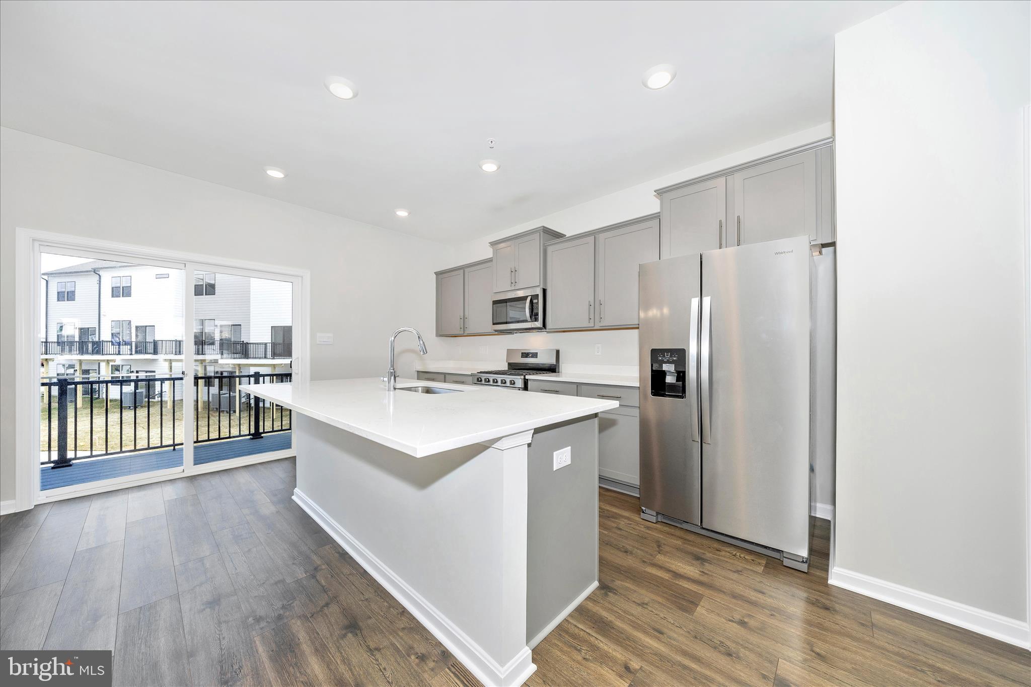 726 Compass Way Frederick, MD 21701 - Photo 17 of 55 a kitchen with stainless steel appliances a refrigerator sink and cabinets