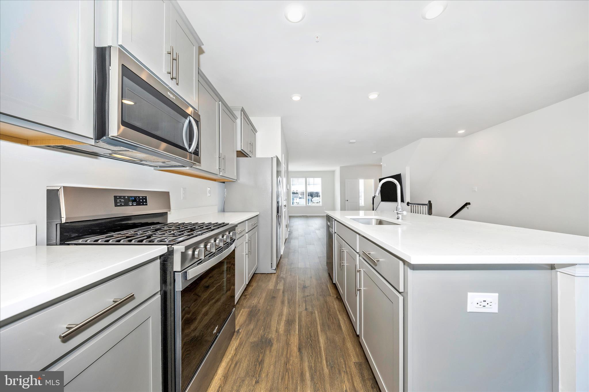 726 Compass Way Frederick, MD 21701 - Photo 19 of 55 a kitchen with stainless steel appliances granite countertop a sink and stove top oven