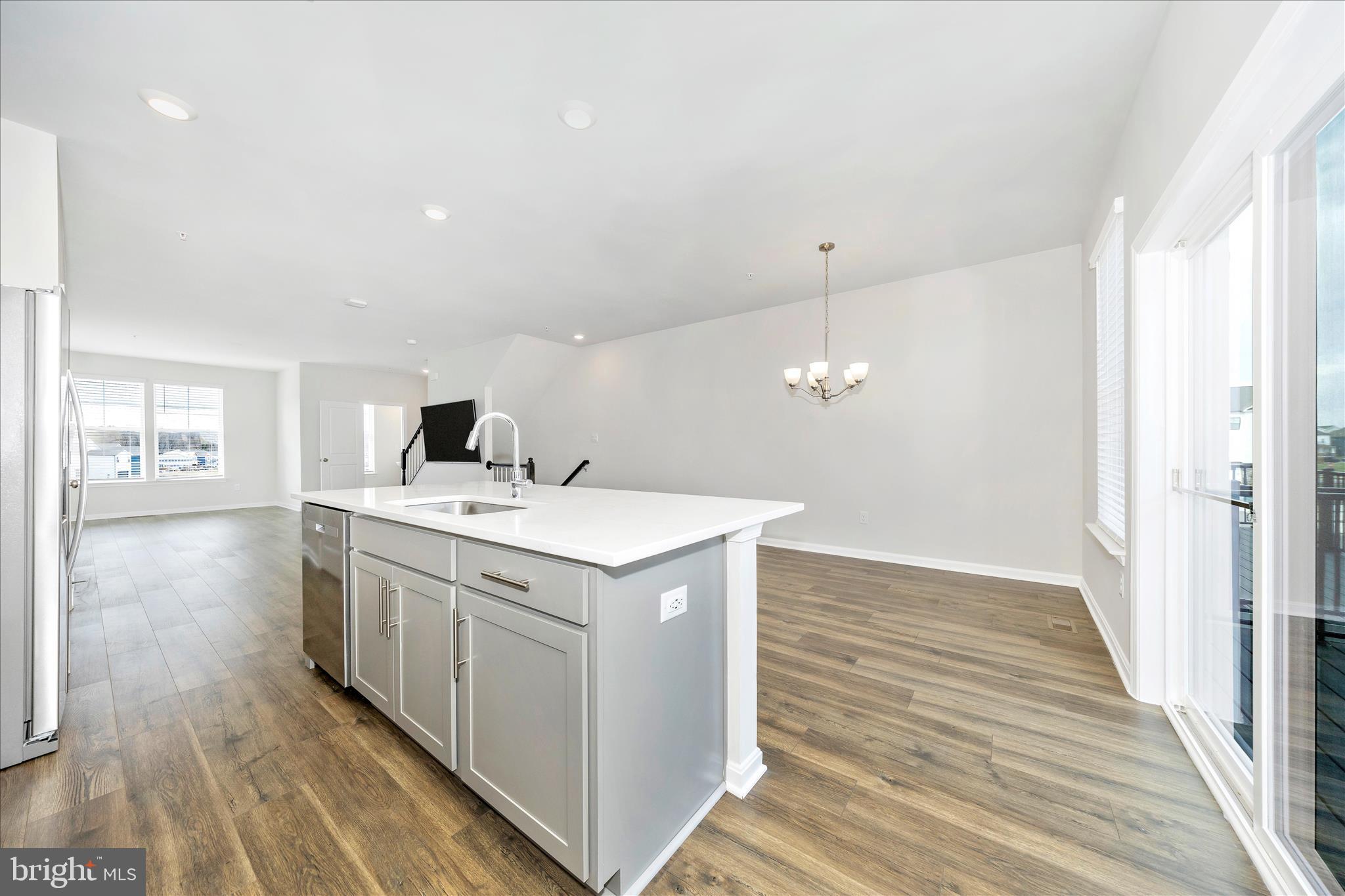 726 Compass Way Frederick, MD 21701 - Photo 21 of 55 a kitchen with a sink and wooden floor