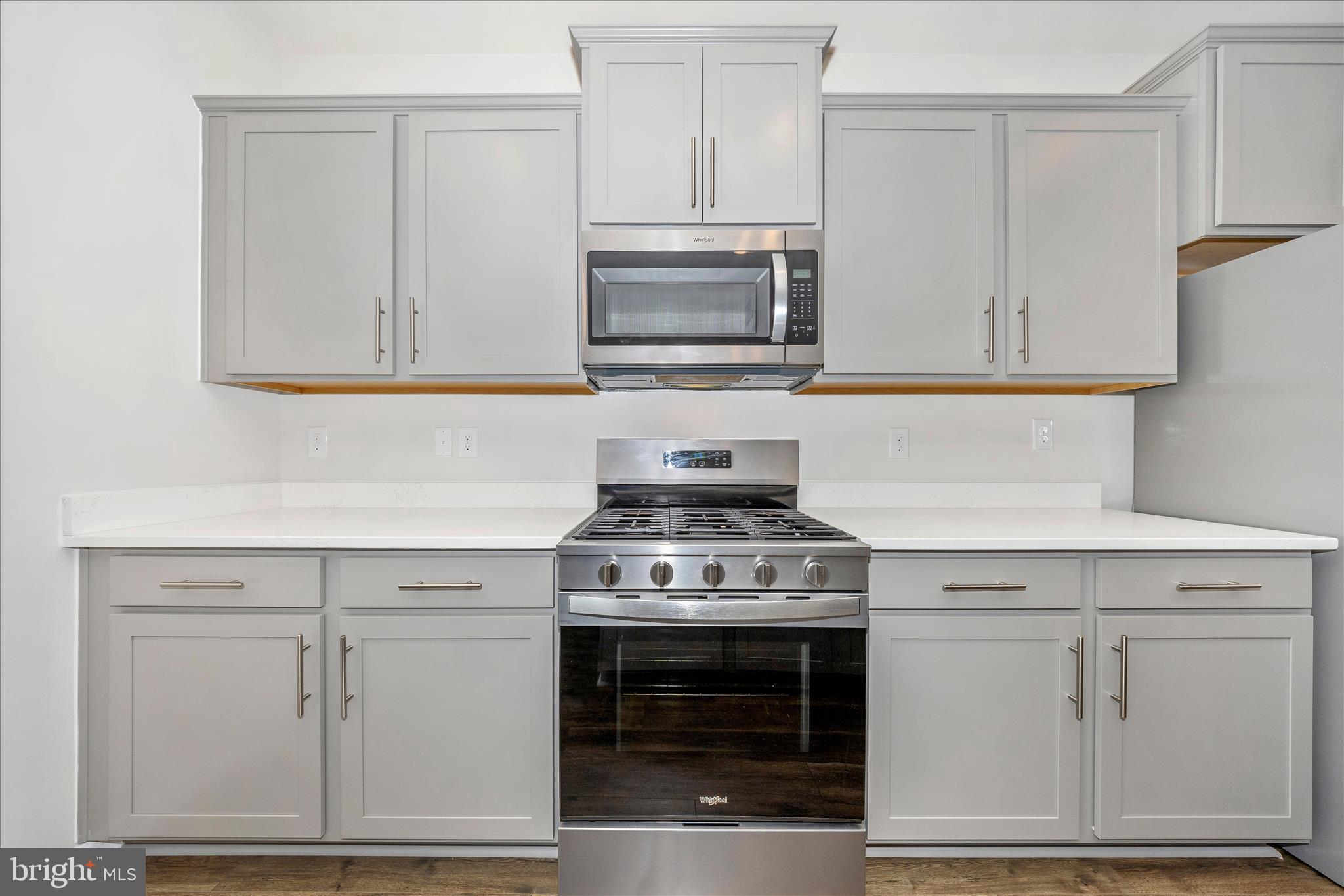 726 Compass Way Frederick, MD 21701 - Photo 22 of 55 a kitchen with white cabinets and stainless steel appliances