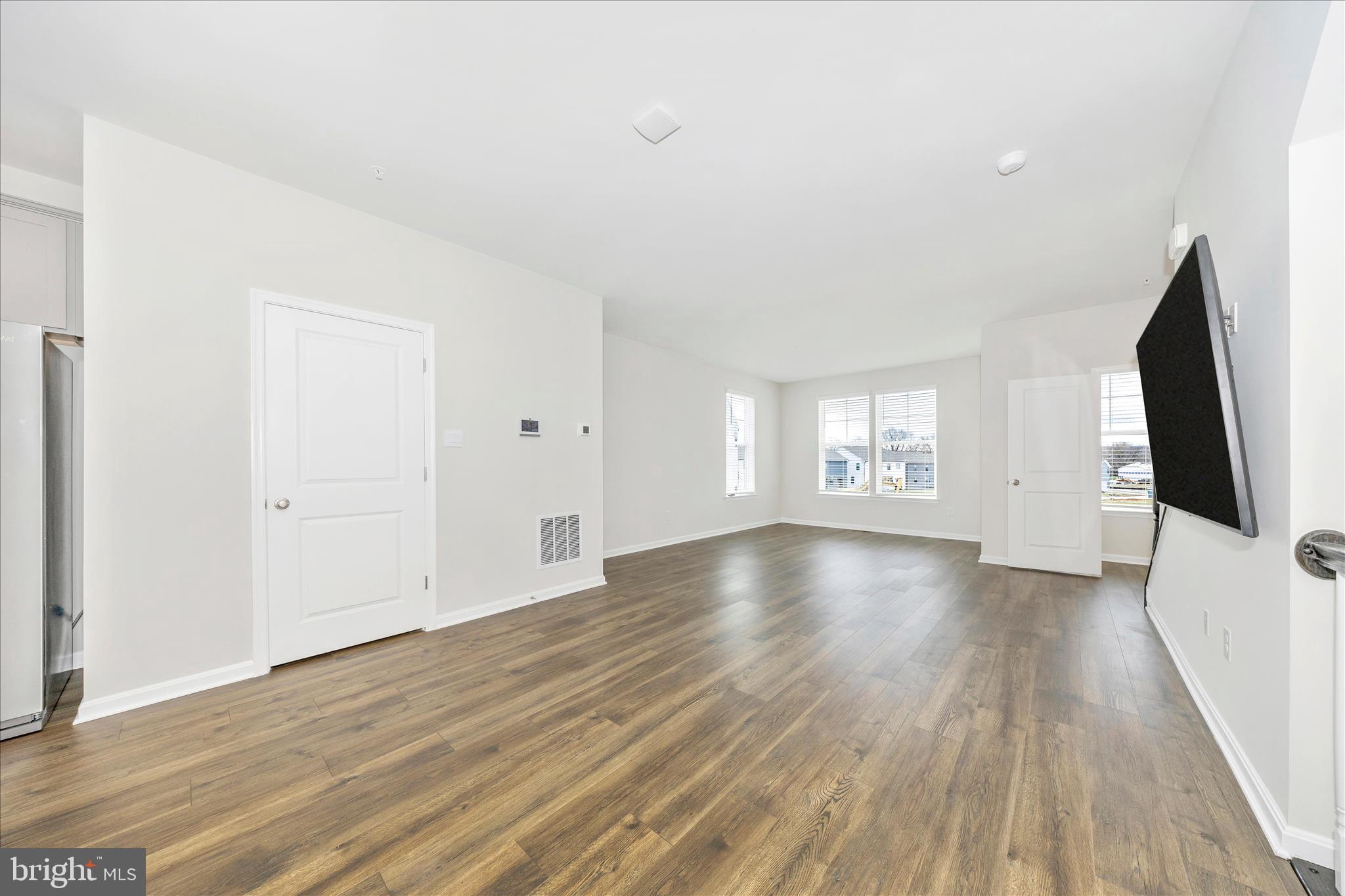 726 Compass Way Frederick, MD 21701 - Photo 23 of 55 a view of a livingroom with wooden floor and window