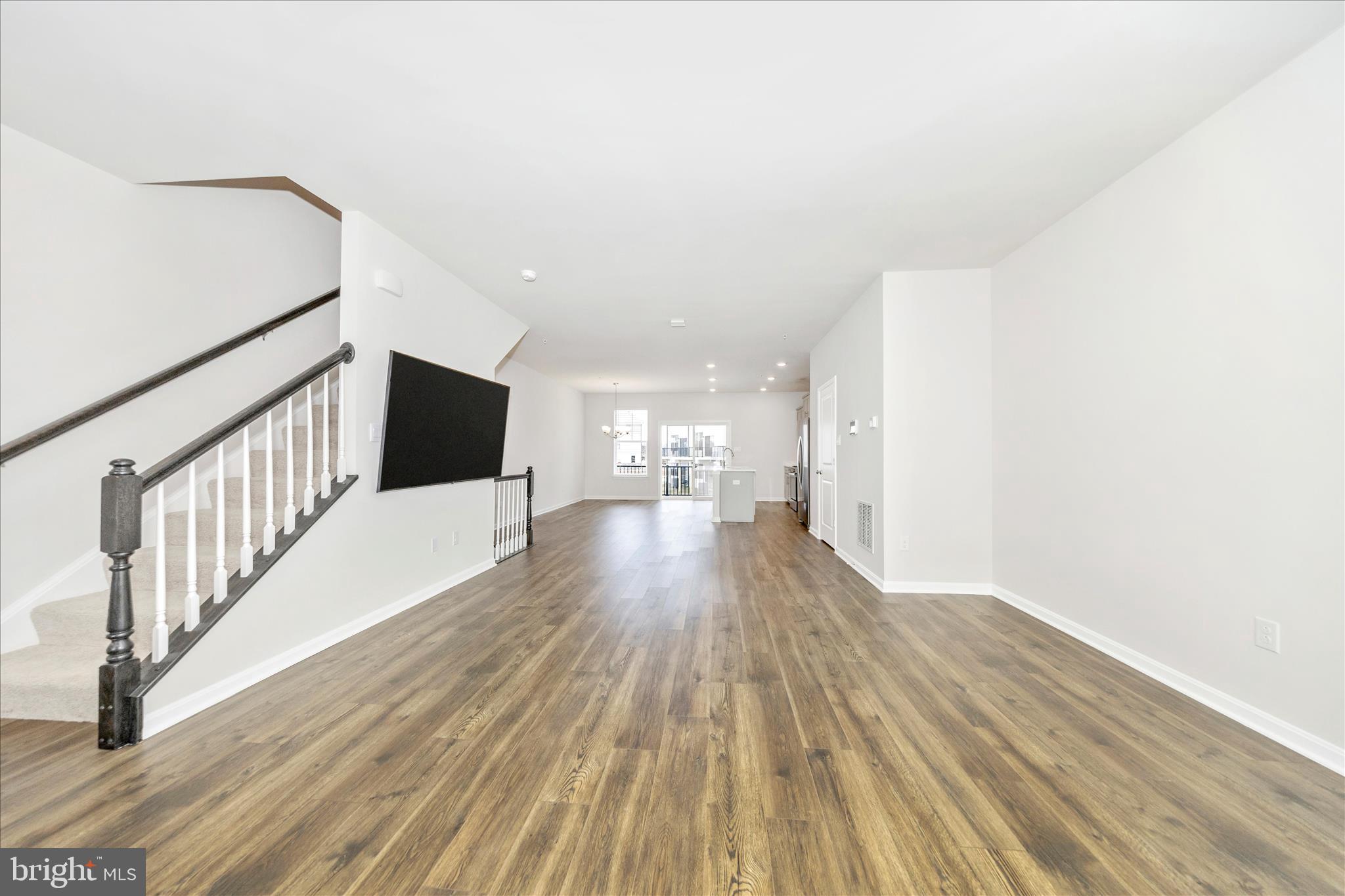 726 Compass Way Frederick, MD 21701 - Photo 25 of 55 a view of empty room with wooden floor