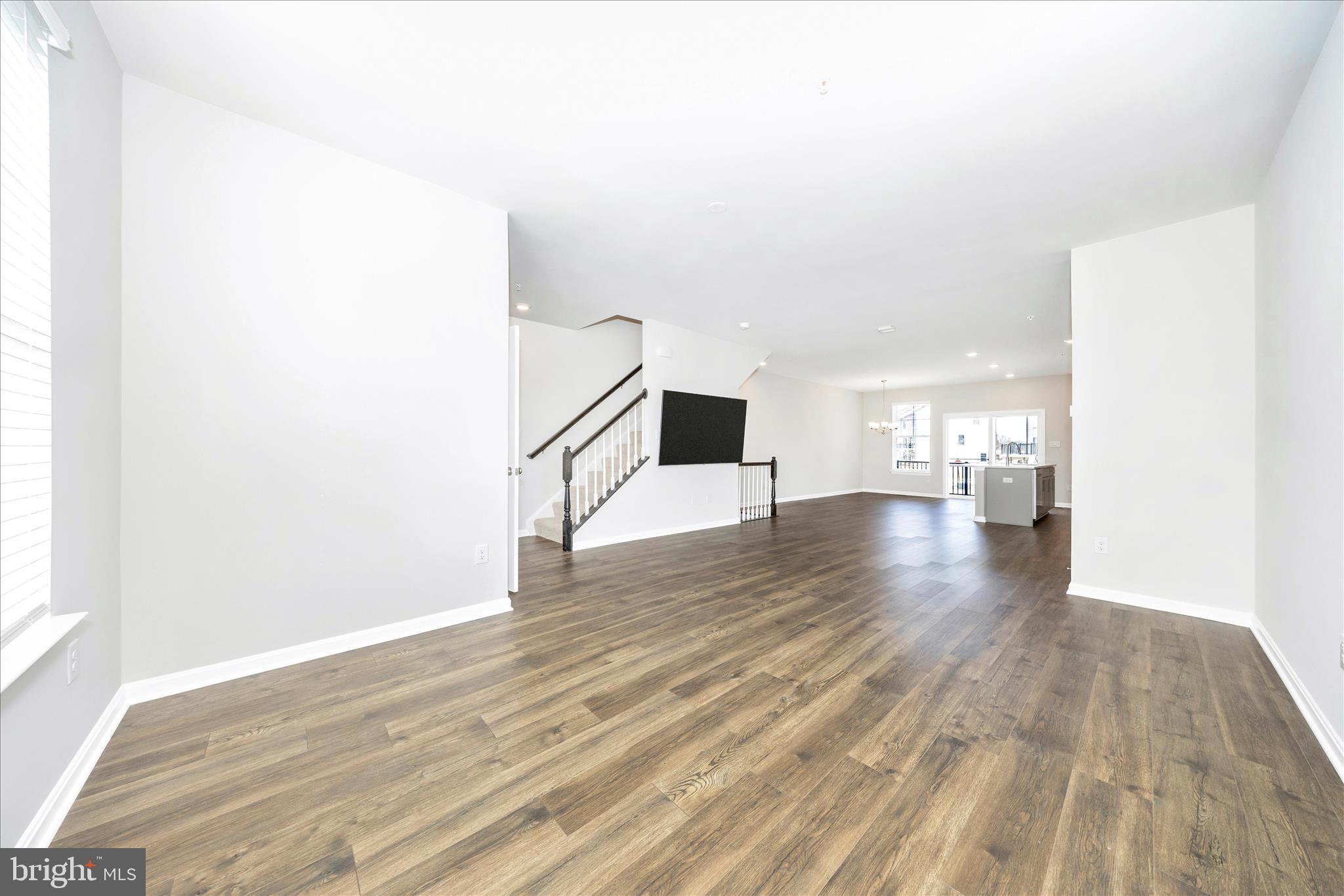 726 Compass Way Frederick, MD 21701 - Photo 26 of 55 a view of empty room with wooden floor