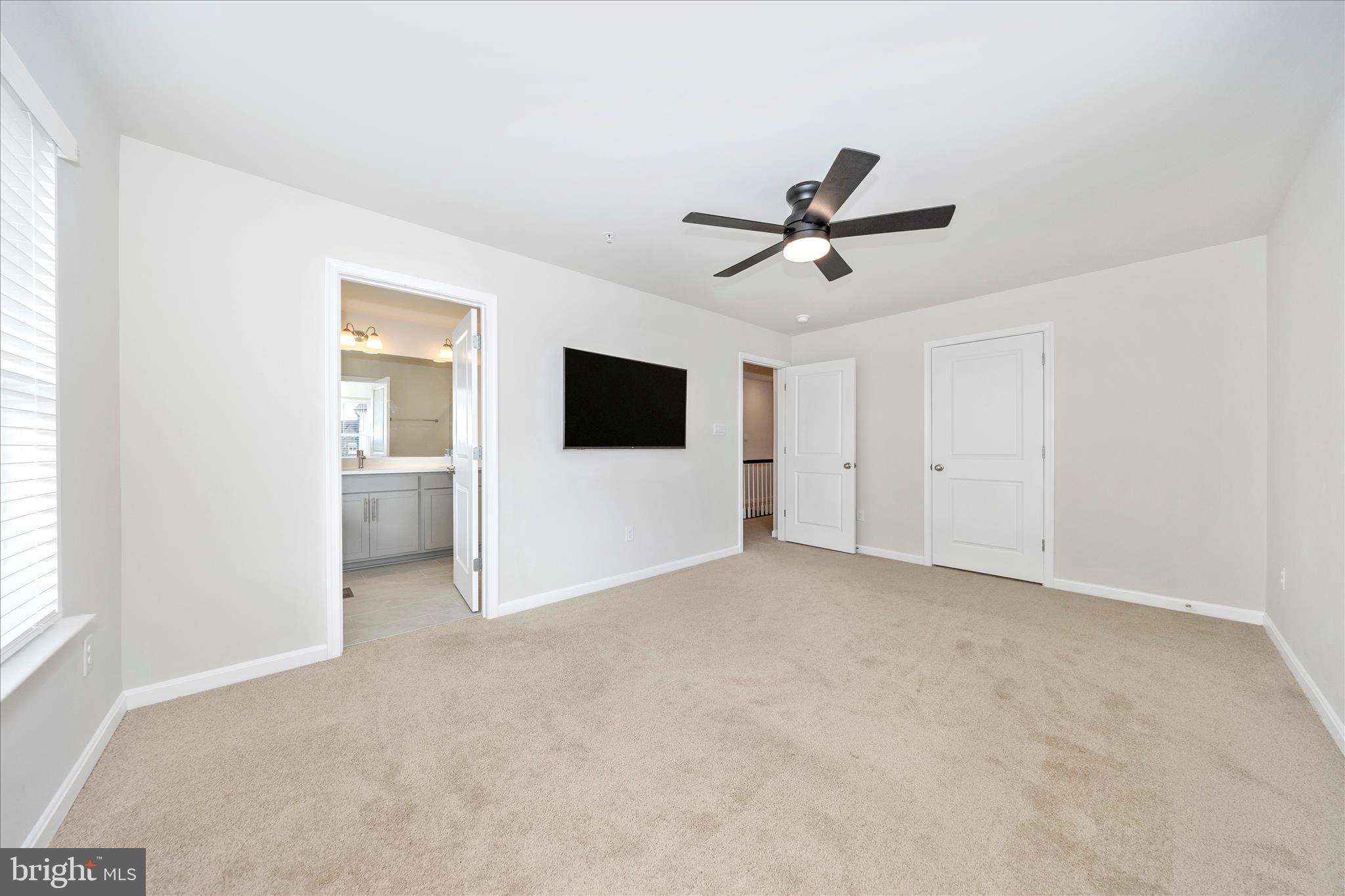 726 Compass Way Frederick, MD 21701 - Photo 36 of 55 a view of a livingroom with a ceiling fan and window