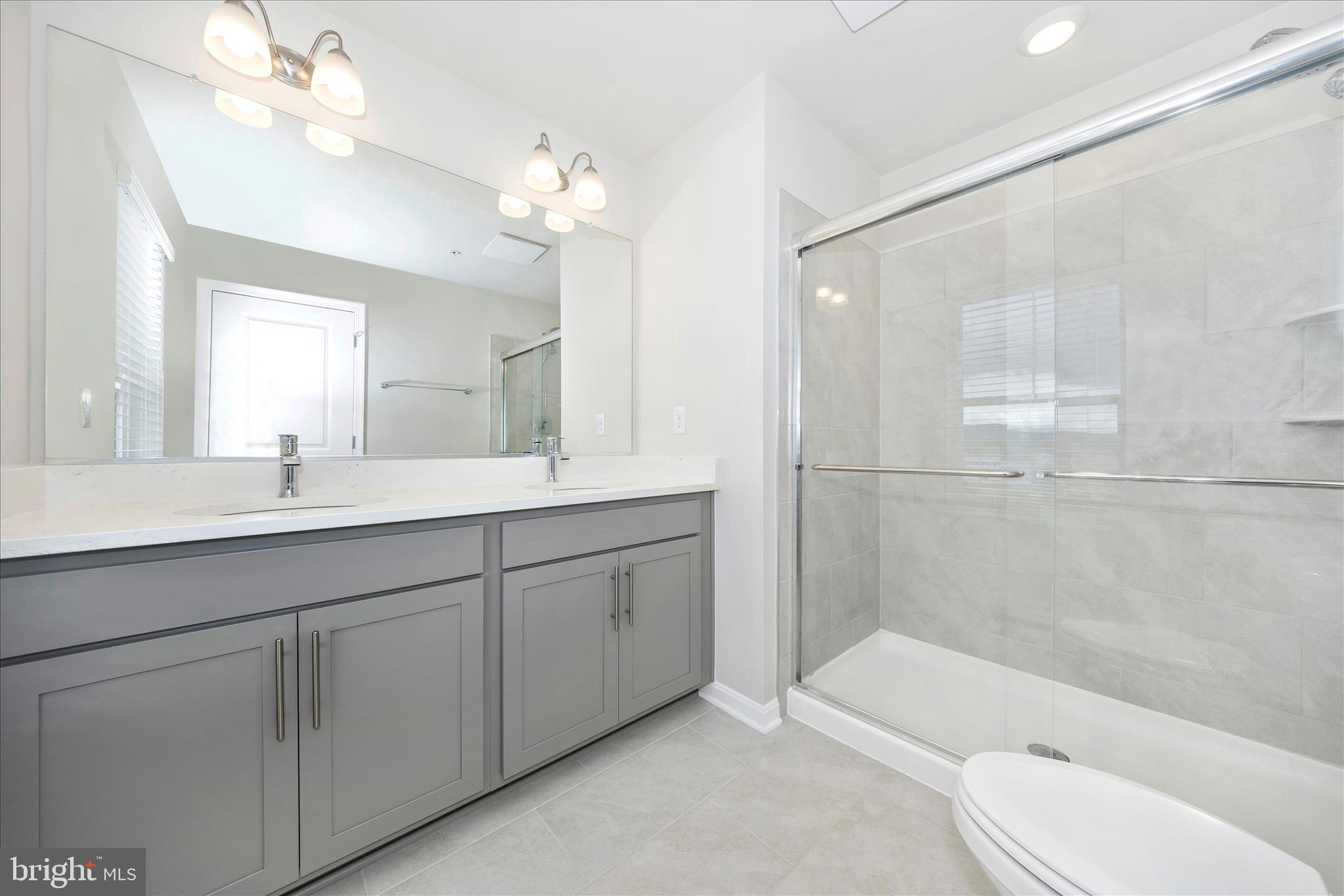 726 Compass Way Frederick, MD 21701 - Photo 38 of 55 a bathroom with a bathtub shower sink and toilet